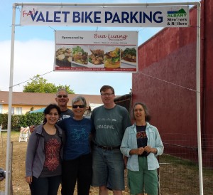 Volunteers Sara, Nick, Sylvia, Ken and Anne beneath the Bua Luang banner after a long & productive day of parking 300+ bikes!